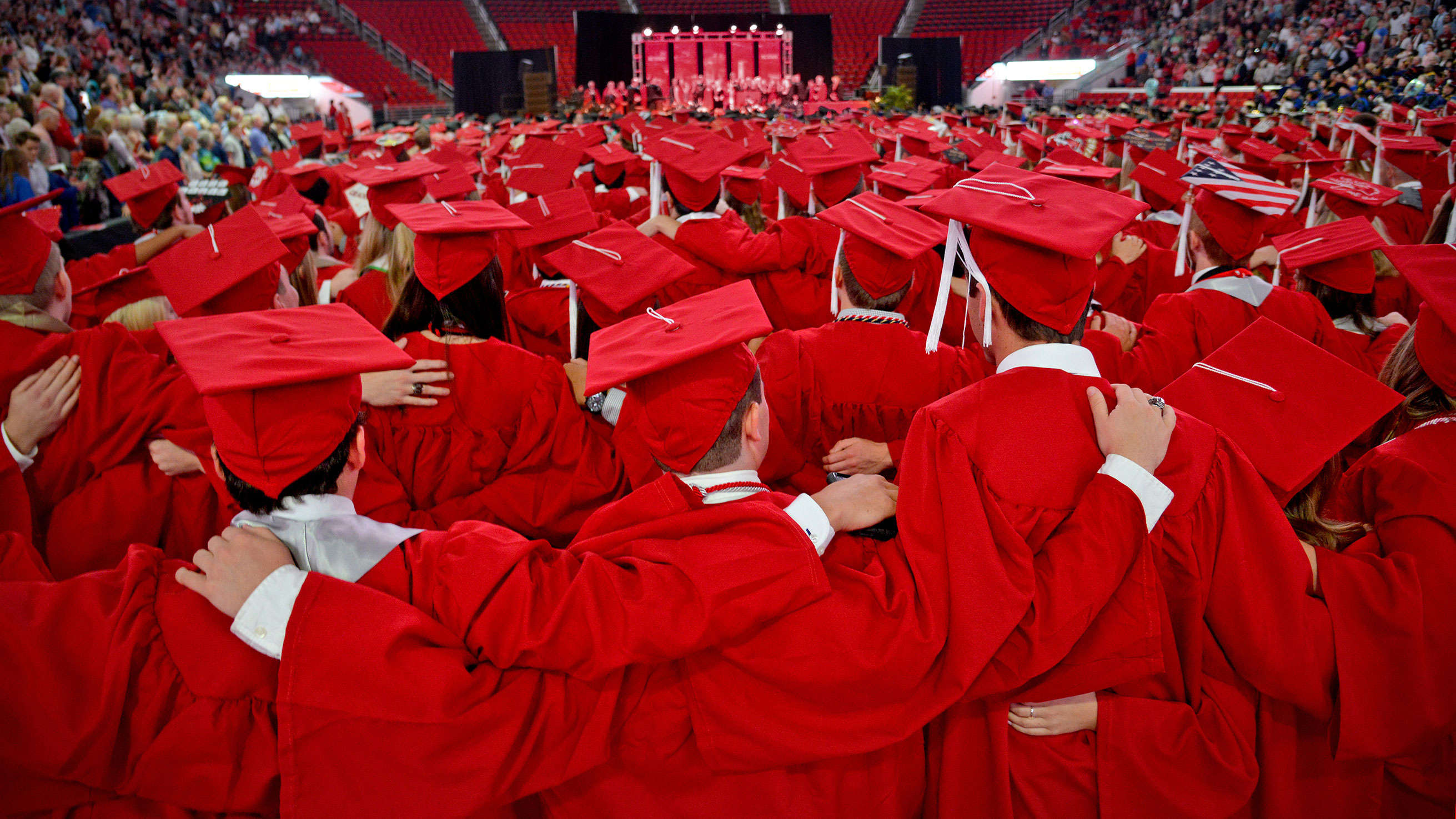 A large group of graduates in red caps and gowns - Giving - College of Natural Resources NC State University
